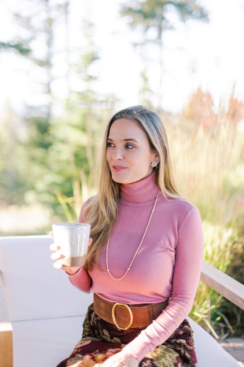 Dr. Azadeh Weber holding a coffee cup