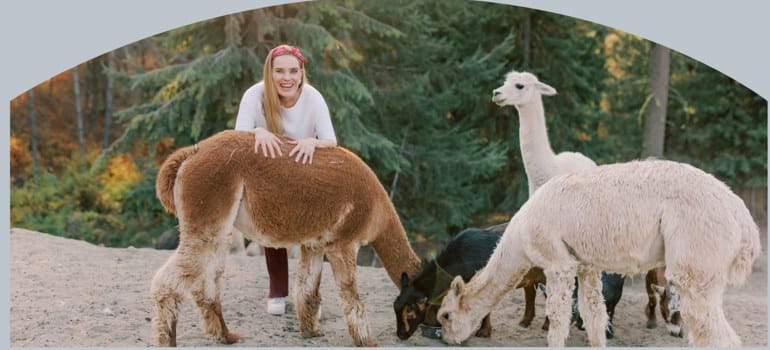 Dr. Azadeh Weber outdoors with alpacas