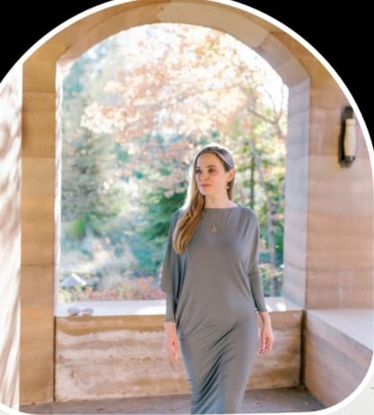 Dr. Azadeh Weber standing in a stone archway